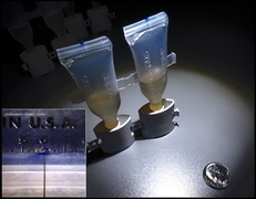 10 micron leak test hole in polymer vials. 
