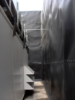 A 24 foot tall, three sided Acoustifence barrier was installed around the industrial chiller on an existing chain link fence. A 24 foot tall, three sided Acoustifence barrier was installed around the industrial chiller on an existing chain link fence.
