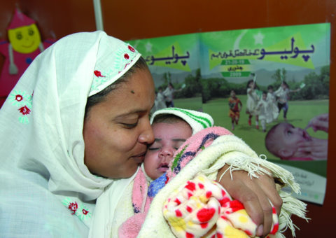 A mother in Pakistan who lost a child to pneumonia embraces her newborn. Baby Asia was just vaccinated against life-threatening Hib pneumonia. (Khalid Raja)