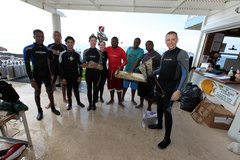 Divers display award-winning trash items picked up during the reef cleanup.