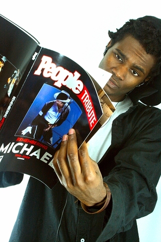C.KhiD poses with a copy of People magazine's Michael Jackson tribute