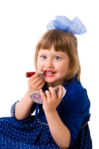 Little Girl playing dress up.