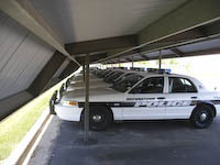 Police vehicles protected by a sturdy, long lasting carport