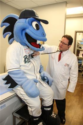 Dr. Steve Heffer, the newly appointed Official General Practitioner for The Bridgeport Bluefish Baseball Team, gives B.B., the team mascot, a full check-up.