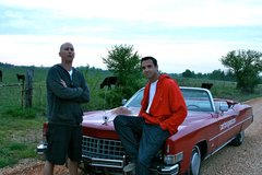 Jorge Gonzalez and Chris Hedgecock during their Route 66 Road Trip stop in Missouri and take a picture in front of their $1,000 1973 Cadillac. 