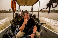 Robert Young Pelton travels by boat to find Riek Machar in South Sudan (c) 2014 Tim Freccia