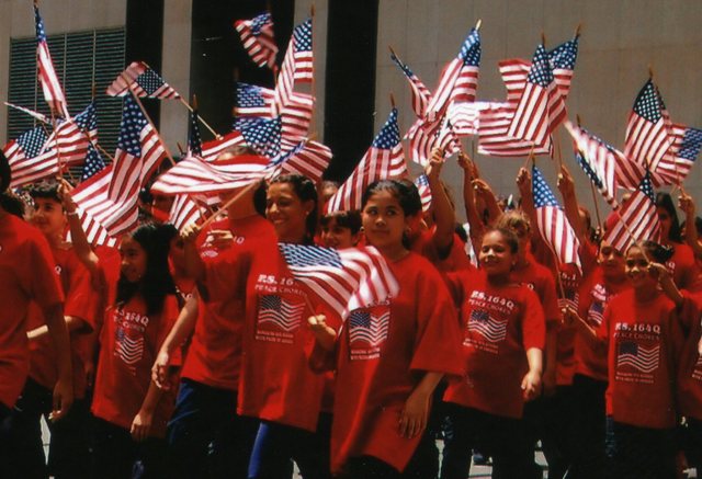 New York City school children enthusiastically participate in the Flag Day Parade each year.