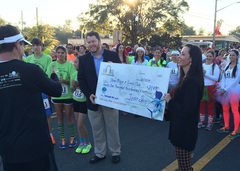 Michael Warren receives a check for the Boys & Girls Clubs of Marion County.