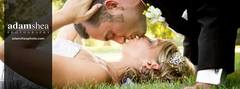 Bride and groom kissing on ground at Pamperin Park in Green Bay, WI.