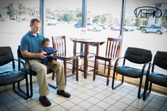 Father and Son Use Tablet While Waiting