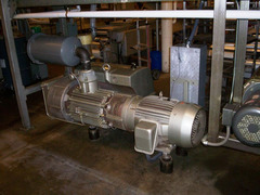 One of four high decibel industrial vacuum pumps that run 24 hours, six days a week at the Alive and Kickin' Pizza manufacturing plant .