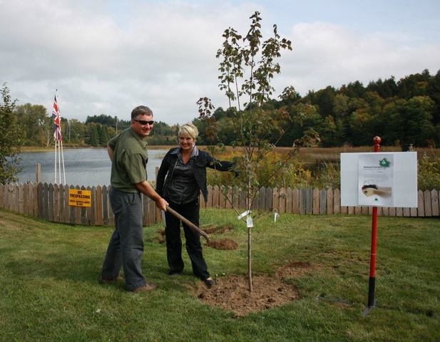 Dave Bishop, General Manager of the Haliburton Forest & Wildlife Reserve performs the ceremonial planting of a Canadian Maple with the help of Caroline Collins, Chair of PNP's Green Team.