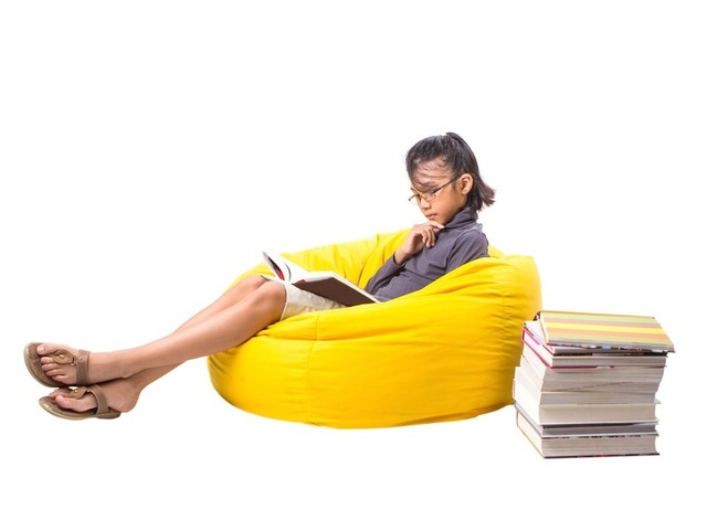 girl sitting on yellow beanbag