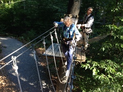Barbara Stetson crosses a rope loops element at The Adventure Park while park president, Bahman Azarm, looks on. (Photo: Anthony Wellman, Outdoor Ventures)