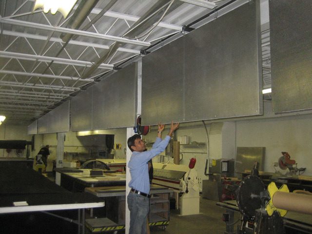 Quiet-Cloud panels hung vertically in an industrial warehouse
