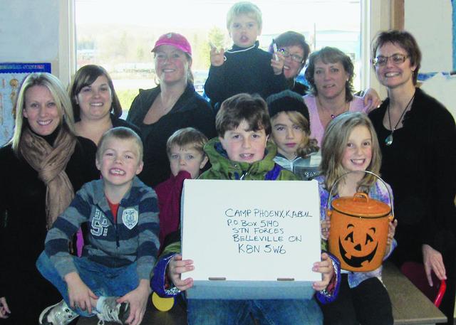 Kids surrounded by PNP Staff in the back row.