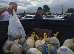 Bobbe Erlinger helps load a truck full of Turkeys and canned goods. 