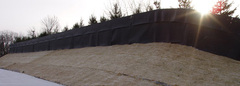 Completed noise barrier berm featuring Acoustifence