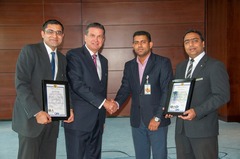 Mr. Suraj Veetil from Quality Registrar Systems presents the certificates to Mr. Stefan Gaessler, General Manager of Hyatt Capital Gate Abu Dhabi and his Team.