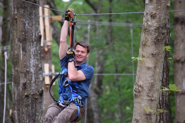 TreeTop Adventures Owner Chris "Topher" Kerr swings through the trees at Greater Boston's newest outdoor attraction. 
