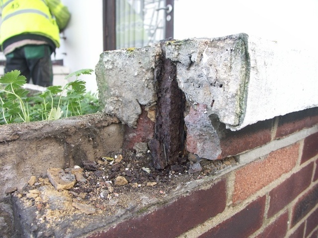 Corrosion of the embedded mild steel splitting bed joints and lifting of the brickwork.