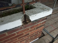 Rusted mild steel breaking out of the brickwork and splitting bed joints.