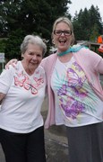 Mariette McDonald and Joanne Sweeney celebrate together through dance and with butterfly shirts.