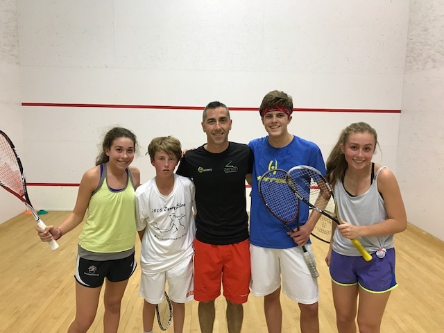 Lee Scott (center) with a few of his students. Scott came from England to start his own academy in Louisville in the hopes of helping to increase community involvement in squash. 