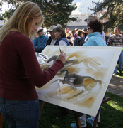 An artist participates in the QuickDraw event on the Town Square.