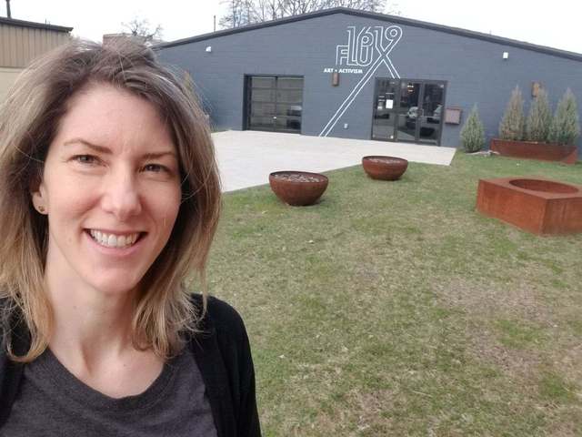 Megan Bayles Bartley, a licensed therapist in Louisville, KY, standing outside the new 1619 Flux: Art + Activism building in the city's Portland neighborhood.