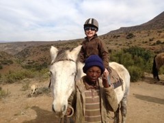 Kent Redding's son, Tate (7), enjoys pony trekking in Lesotho, Africa, on a summer family safari © Africa Adventure Consultants