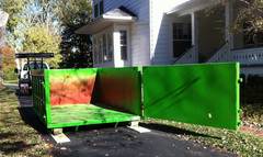Moon's residential size dumpsters are driveway safe and placed on boards during delivery for surface protection.