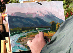 An artist paints during the QuickDraw Event at the Fall Arts Festival